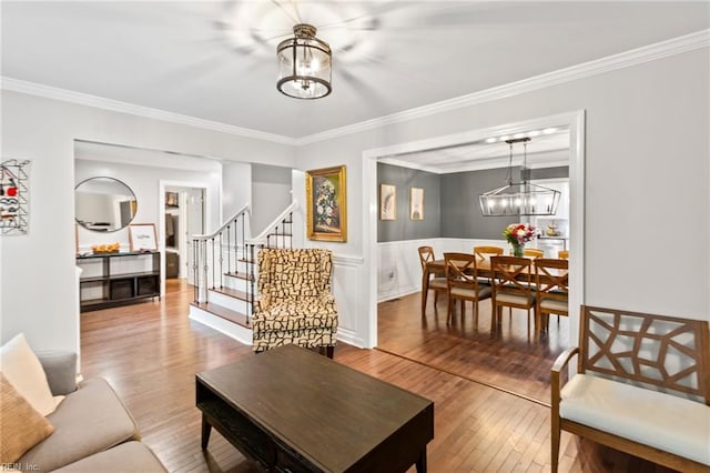 527 Lakeshead Dr, Williamsburg, VA 23185 - living area with a chandelier, ornamental molding, hardwood / wood-style flooring, stairway, and wainscoting