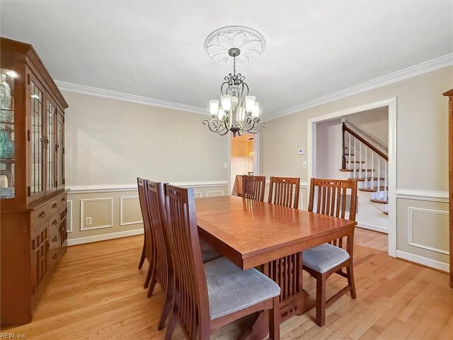 122 Archer Rd, Newport News, VA 23606 - dining space with ornamental molding, a chandelier, light wood-style floors, a decorative wall, and wainscoting