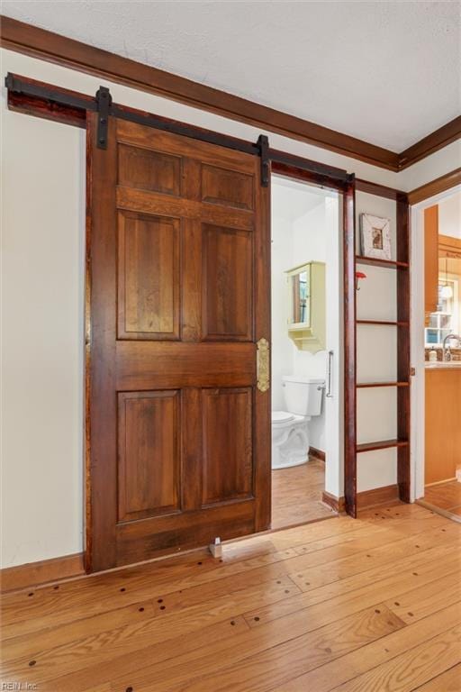 122 Archer Rd, Newport News, VA 23606 - entrance foyer featuring a barn door, light wood finished floors, baseboards, and crown molding