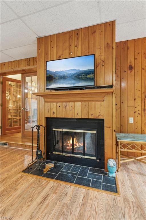 122 Archer Rd, Newport News, VA 23606 - detailed view of a fireplace with flush hearth, wood finished floors, and wood walls