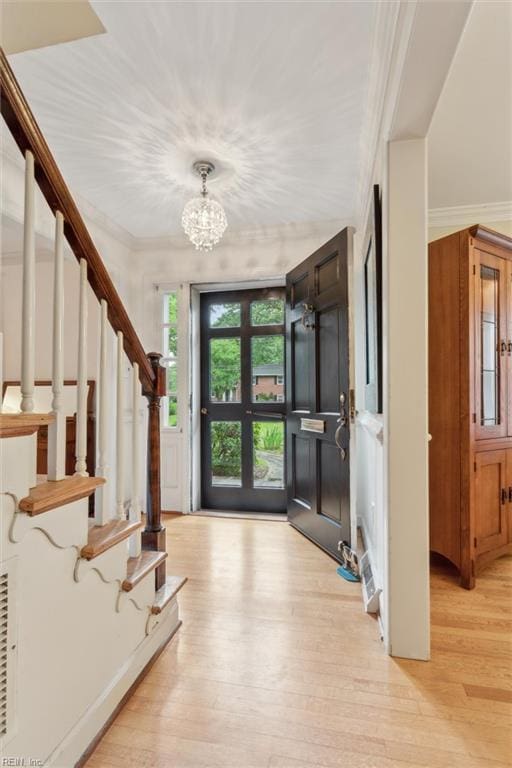 122 Archer Rd, Newport News, VA 23606 - foyer entrance with light wood-type flooring, stairs, a chandelier, and ornamental molding