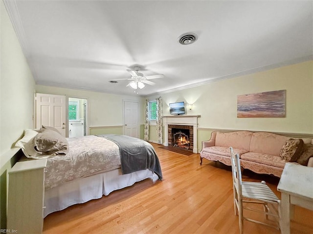 122 Archer Rd, Newport News, VA 23606 - bedroom with crown molding, a brick fireplace, light wood-style flooring, and a ceiling fan