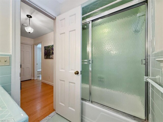 122 Archer Rd, Newport News, VA 23606 - full bath with shower / bath combination with glass door, wood finished floors, and baseboards