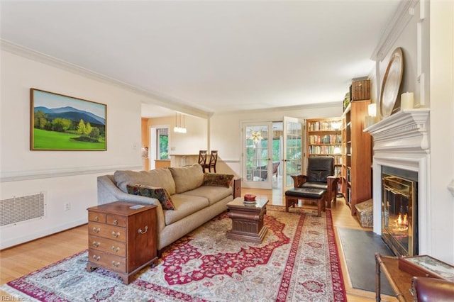 122 Archer Rd, Newport News, VA 23606 - living room featuring wood finished floors, crown molding, a glass covered fireplace, and french doors