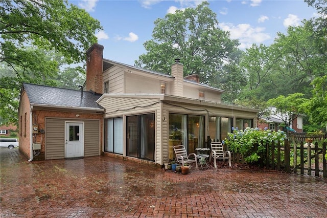 122 Archer Rd, Newport News, VA 23606 - back of house featuring a sunroom, a chimney, and fence