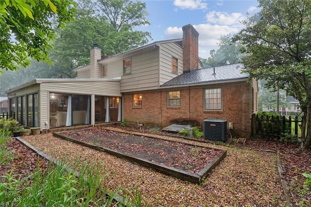 122 Archer Rd, Newport News, VA 23606 - rear view of property featuring a chimney, a sunroom, central air condition unit, brick siding, and fence