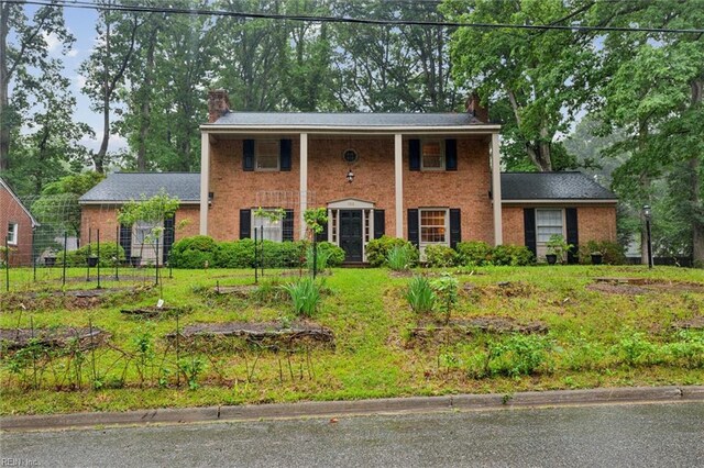 122 Archer Rd, Newport News, VA 23606 - view of front of home with a chimney, brick siding, and fence