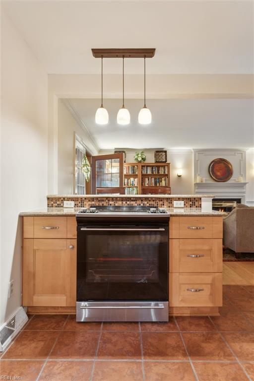 122 Archer Rd, Newport News, VA 23606 - kitchen with gas stove, light brown cabinetry, tasteful backsplash, open floor plan, and ornamental molding
