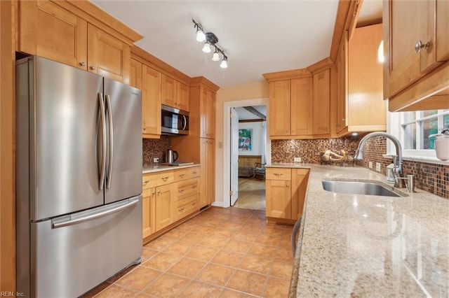 122 Archer Rd, Newport News, VA 23606 - kitchen featuring appliances with stainless steel finishes, a sink, tasteful backsplash, light stone counters, and light tile patterned floors