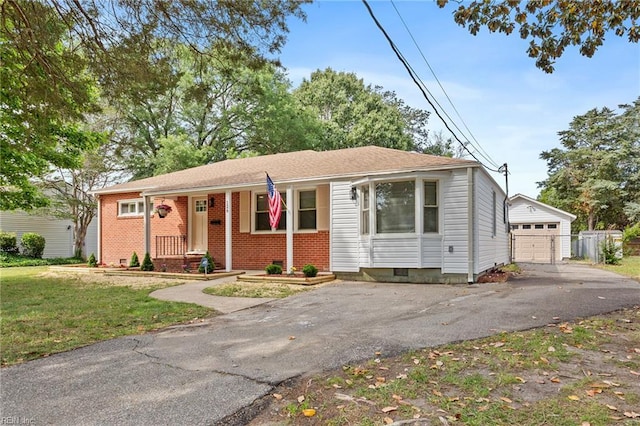 126 Kerlin Rd, Newport News, VA 23601 - view of front of house with an outdoor structure, driveway, a detached garage, a front yard, and brick siding