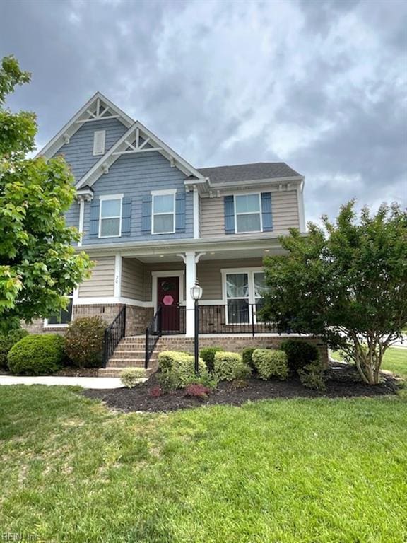 20 Pickins Dr, Poquoson, VA 23662 - craftsman house featuring a front yard, covered porch, and brick siding