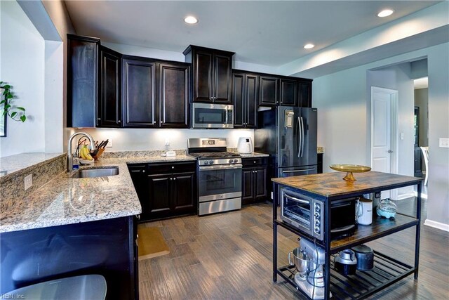 20 Pickins Dr, Poquoson, VA 23662 - kitchen featuring stainless steel appliances, a sink, light stone countertops, recessed lighting, and dark wood-style flooring