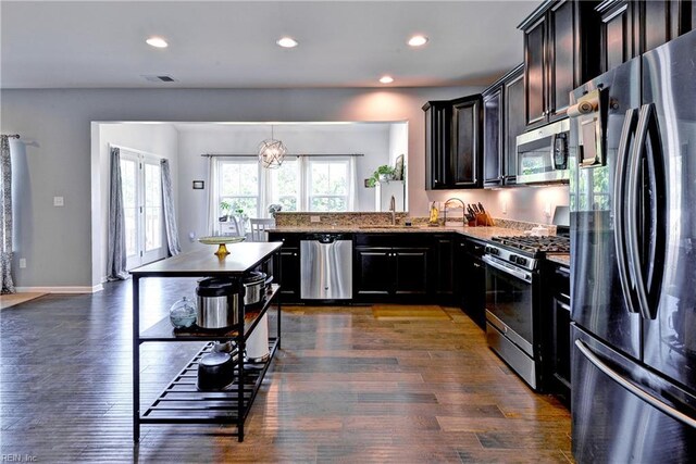 20 Pickins Dr, Poquoson, VA 23662 - kitchen featuring appliances with stainless steel finishes, a sink, light stone countertops, recessed lighting, and dark wood-style floors