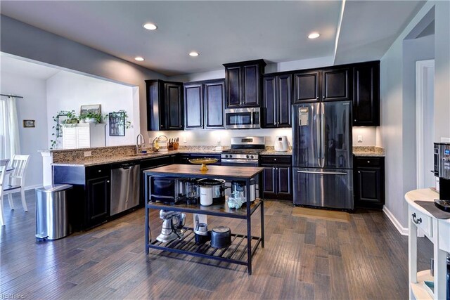 20 Pickins Dr, Poquoson, VA 23662 - kitchen featuring stainless steel appliances, a peninsula, dark wood-style flooring, recessed lighting, and light stone countertops