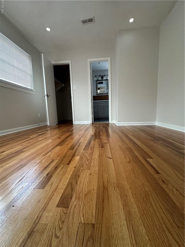 2800 Candlewood Cir, Chesapeake, VA 23324 - unfurnished bedroom featuring wood finished floors, baseboards, recessed lighting, a walk in closet, and ensuite bathroom