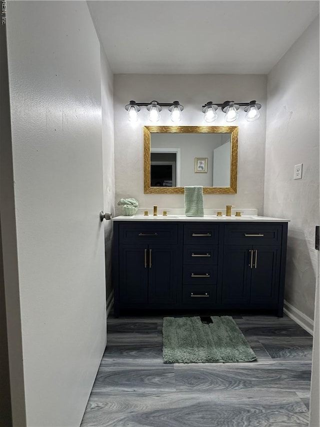2800 Candlewood Cir, Chesapeake, VA 23324 - bathroom featuring wood finished floors, double vanity, and baseboards