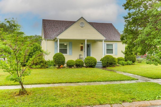8140 Kenwood Dr, Norfolk, VA 23518 - bungalow-style house with roof with shingles, a front yard, and a porch