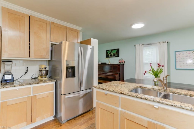 8140 Kenwood Dr, Norfolk, VA 23518 - kitchen with stainless steel fridge, light brown cabinets, a sink, light wood-style flooring, and backsplash