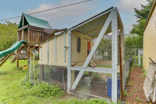 8140 Kenwood Dr, Norfolk, VA 23518 - view of playground with exterior structure, fence, and an outbuilding