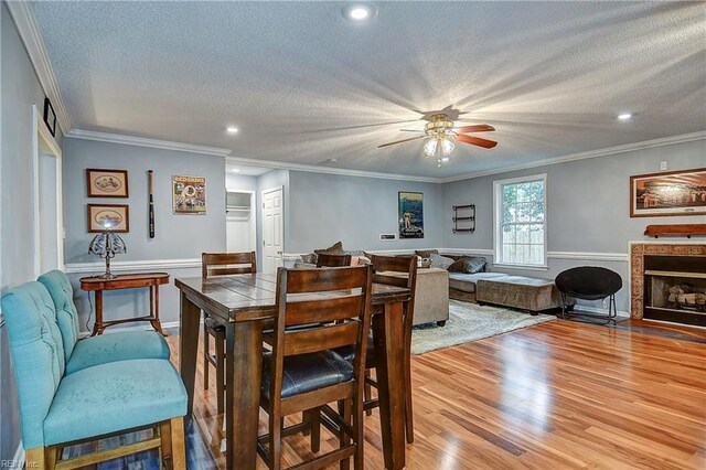 3582 Tennessee Ave, Norfolk, VA 23502 - dining space featuring a textured ceiling, ceiling fan, wood finished floors, wainscoting, and ornamental molding