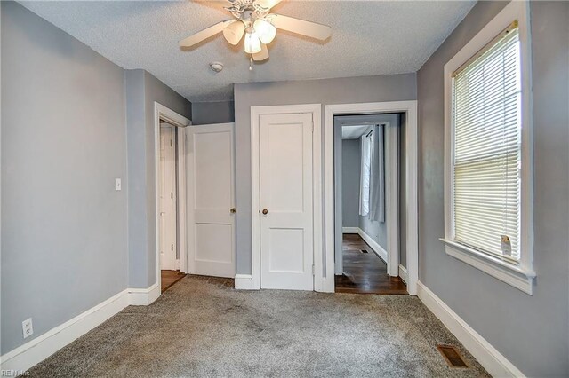 3582 Tennessee Ave, Norfolk, VA 23502 - unfurnished bedroom featuring carpet, multiple windows, a textured ceiling, baseboards, and ceiling fan