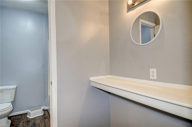 3582 Tennessee Ave, Norfolk, VA 23502 - bathroom featuring toilet, wood finished floors, baseboards, and a textured ceiling