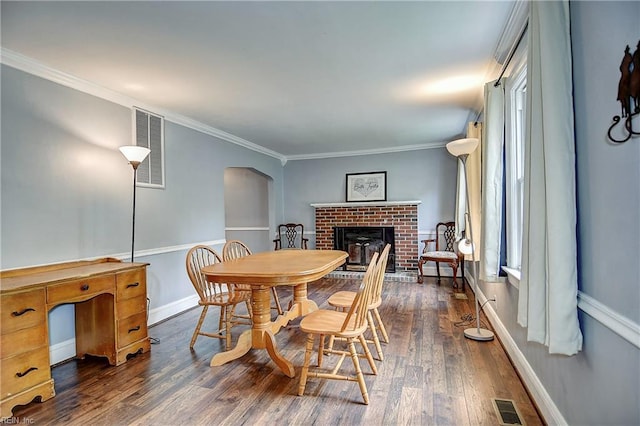 3582 Tennessee Ave, Norfolk, VA 23502 - dining area featuring dark wood finished floors, arched walkways, ornamental molding, a brick fireplace, and baseboards