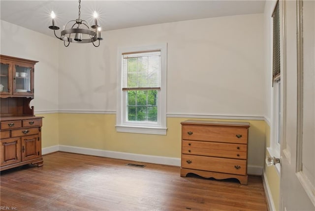 116 Sycamore Rd, Franklin, VA 23851 - dining area featuring a chandelier, wood finished floors, and baseboards
