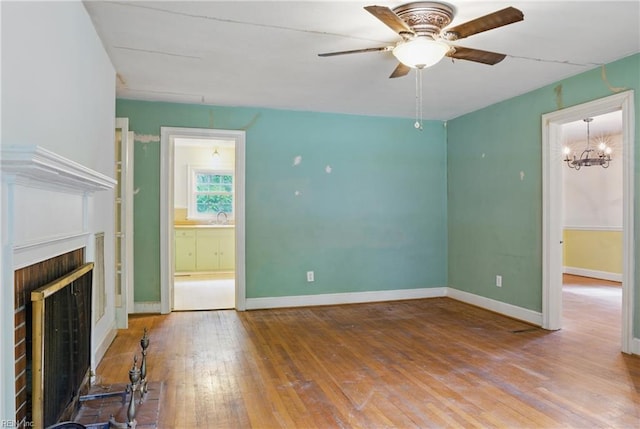 116 Sycamore Rd, Franklin, VA 23851 - unfurnished living room with a ceiling fan, hardwood / wood-style flooring, a chandelier, a fireplace, and baseboards