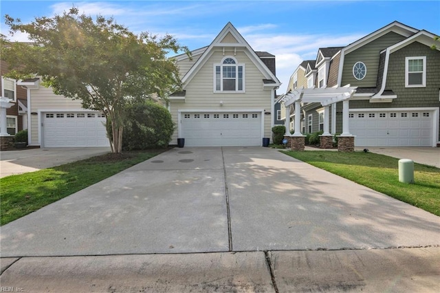 107 Hamilton Ct, Suffolk, VA 23435 - view of front facade featuring an attached garage, concrete driveway, and a pergola
