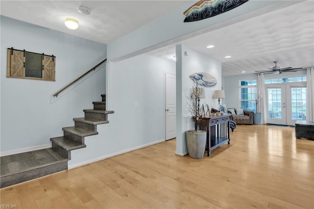 107 Hamilton Ct, Suffolk, VA 23435 - stairway featuring wood finished floors, french doors, baseboards, a ceiling fan, and recessed lighting