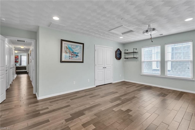107 Hamilton Ct, Suffolk, VA 23435 - spare room with attic access, wood finished floors, baseboards, and recessed lighting