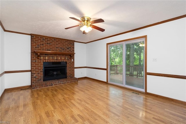 25 Hunter Trce, Hampton, VA 23669 - unfurnished living room with wood finished floors, baseboards, crown molding, ceiling fan, and a brick fireplace