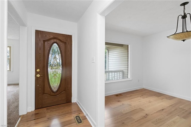 25 Hunter Trce, Hampton, VA 23669 - entryway featuring healthy amount of natural light, light wood-type flooring, a textured ceiling, and baseboards