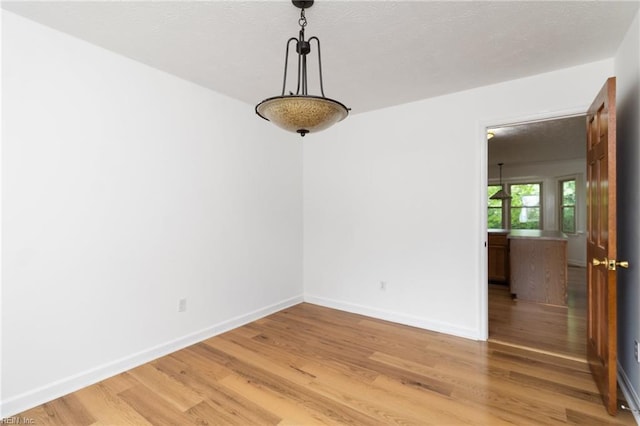 25 Hunter Trce, Hampton, VA 23669 - empty room with light wood finished floors, baseboards, and a textured ceiling