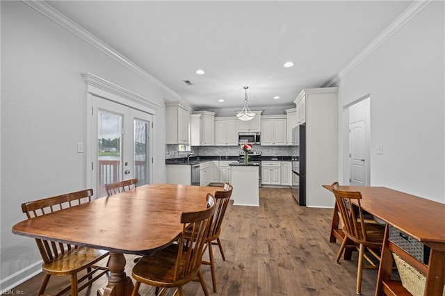 3925 Grand Isle Dr, Chesapeake, VA 23323 - dining room featuring ornamental molding, dark wood-type flooring, and recessed lighting