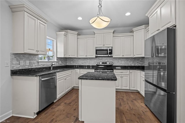 3925 Grand Isle Dr, Chesapeake, VA 23323 - kitchen with stainless steel appliances, a sink, a center island, tasteful backsplash, and ornamental molding