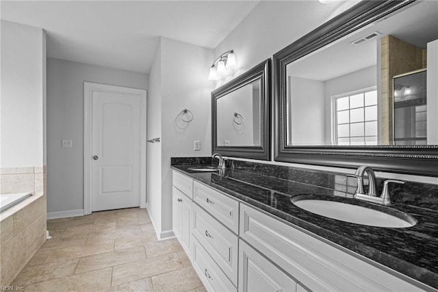 3925 Grand Isle Dr, Chesapeake, VA 23323 - full bath with baseboards, double vanity, stone tile floors, a relaxing tiled tub, and a tile shower