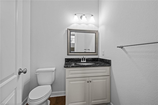3925 Grand Isle Dr, Chesapeake, VA 23323 - bathroom featuring baseboards, vanity, toilet, and wood finished floors
