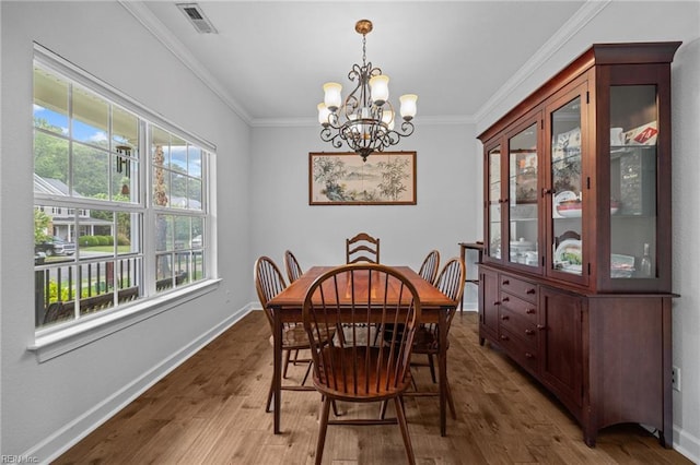 3925 Grand Isle Dr, Chesapeake, VA 23323 - dining space with a chandelier, wood finished floors, ornamental molding, and baseboards