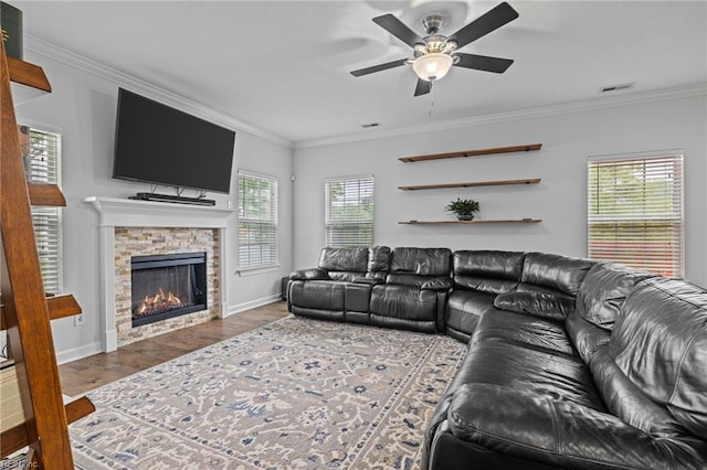 3925 Grand Isle Dr, Chesapeake, VA 23323 - living room featuring a ceiling fan, crown molding, baseboards, wood finished floors, and a stone fireplace