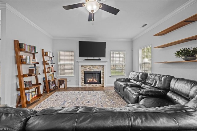 3925 Grand Isle Dr, Chesapeake, VA 23323 - living room with wood finished floors, ceiling fan, crown molding, a stone fireplace, and baseboards