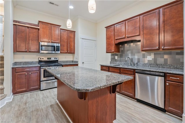 1278 Little Bay Ave Unit B, Norfolk, VA 23503 - kitchen with appliances with stainless steel finishes, a sink, light wood-style flooring, a kitchen island, and crown molding
