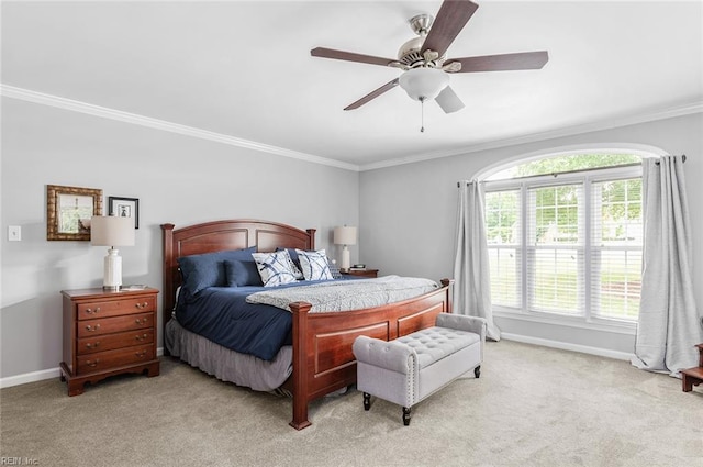 bedroom with crown molding, light colored carpet, baseboards, and ceiling fan