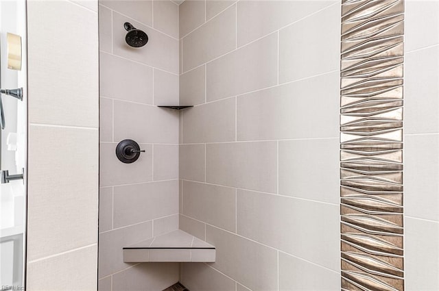 full bath with a tile shower