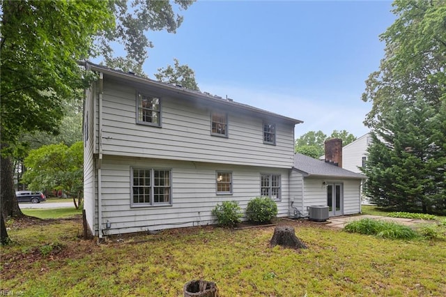 155 Wilderness Rd, Hampton, VA 23669 - back of property featuring a yard, a chimney, and central AC unit