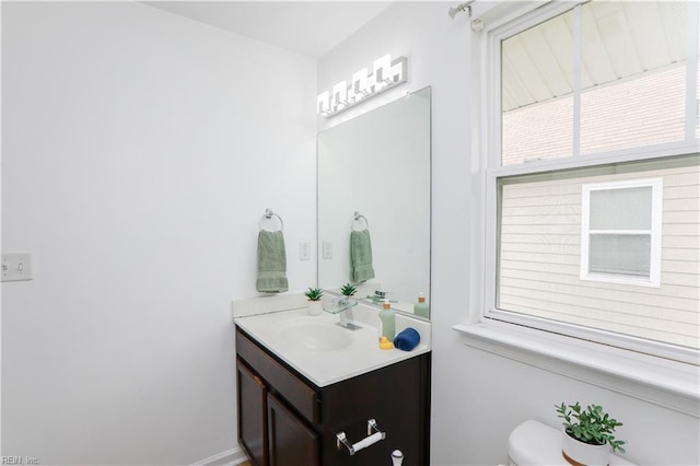 1060 Fairgrounds Ln, Suffolk, VA 23434 - half bathroom featuring toilet, vanity, and baseboards
