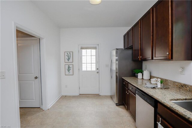 1060 Fairgrounds Ln, Suffolk, VA 23434 - kitchen with dishwasher, light stone countertops, baseboards, and dark brown cabinetry