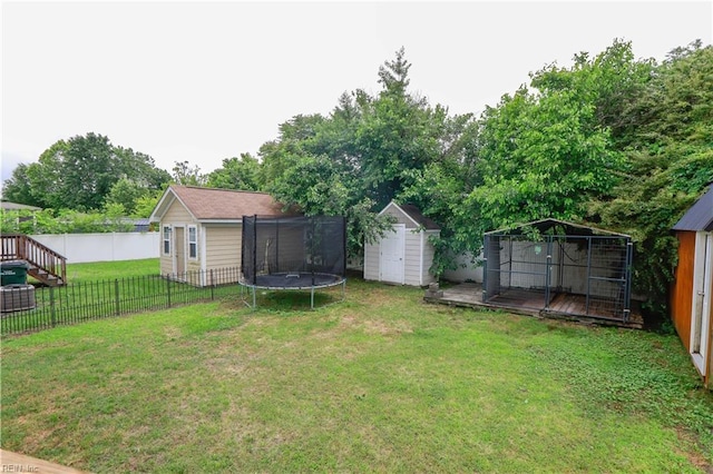 1060 Fairgrounds Ln, Suffolk, VA 23434 - view of yard with a trampoline, a shed, an outbuilding, and a deck