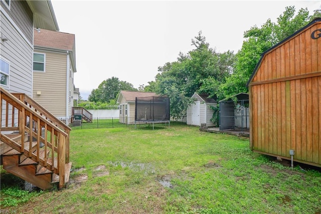 1060 Fairgrounds Ln, Suffolk, VA 23434 - view of yard featuring a storage unit, an outbuilding, a trampoline, and stairway